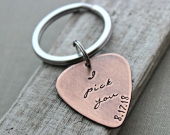 May include: Copper guitar pick keychain with the text "I pick you" and the date "8-17-18" engraved on it.