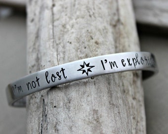 I'm not lost I'm exploring - Hand stamped aluminum bracelet - 1/4 Inch Bangle Silver tone Cuff Bracelet - Compass - Traveler - wanderer