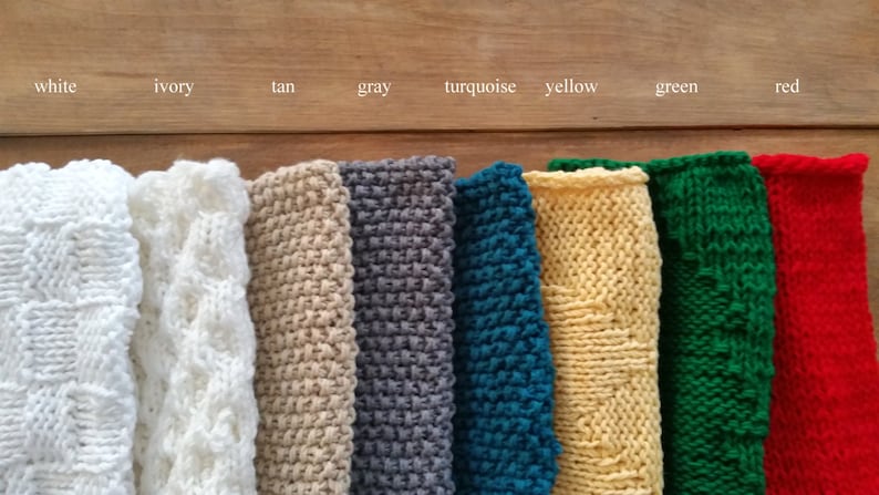 May include: Ten knitted swatches in different colors, including white, ivory, tan, gray, turquoise, yellow, green, and red. The swatches are arranged in a row from left to right.