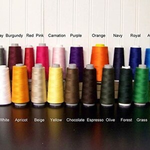 May include: A collection of 24 spools of thread in various colors, including teal, aqua, gray, burgundy, red, pink, carnation, purple, orange, navy, royal, azure, sky, black, ivory, white, apricot, beige, yellow, chocolate, espresso, olive, forest, grass, pear, and lavender.