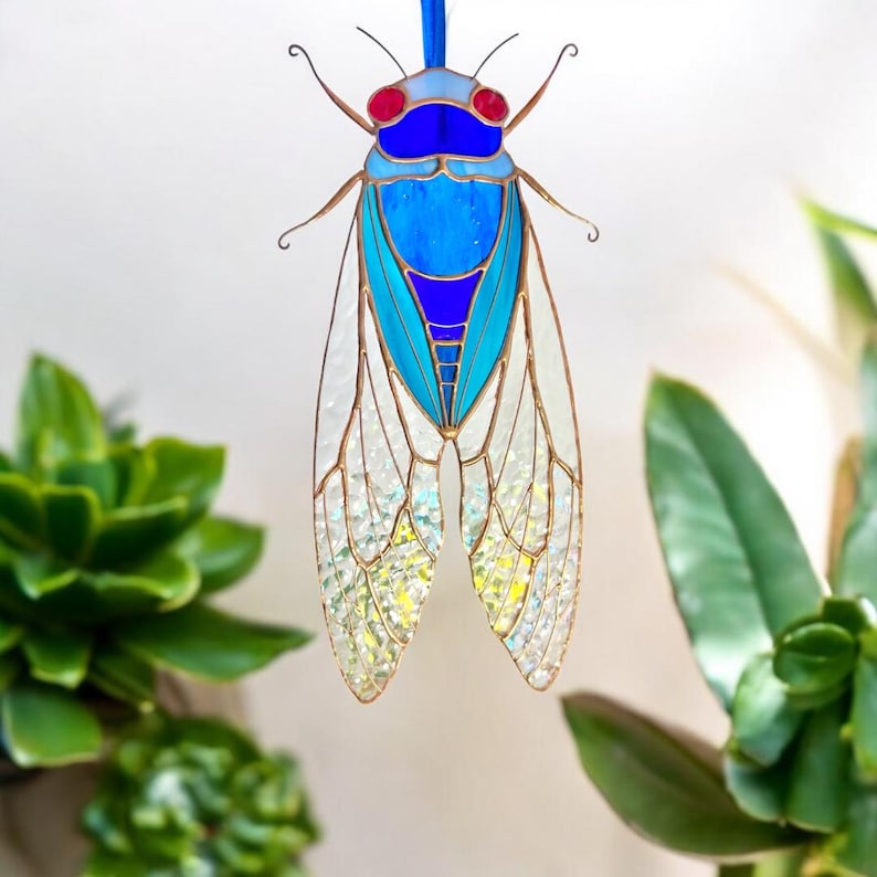 As light passes through, the cicada’s wings glow with colors of the rainbow, creating a magical effect that inspires peace and inner strength.