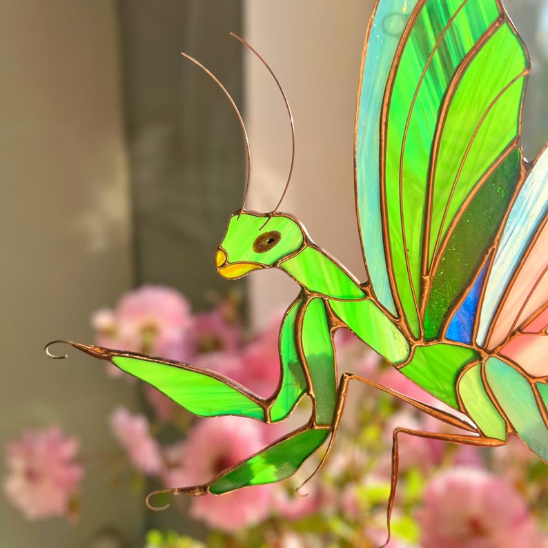 The mantis' elegant form reminds us of the power of quiet observation and inner peace.