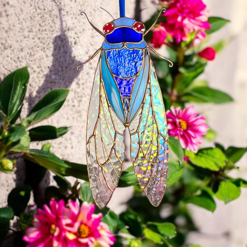 Its wings are made of transparent glass with an enchanting rainbow-like iridescence, giving it a mystical, ethereal glow.