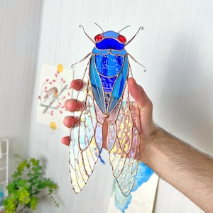 The cicada’s body is darker, contrasting with its iridescent wings, adding depth and a sense of spirit, ideal for anyone seeking a gift with spiritual significance.