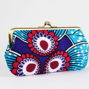 May include: A blue and red floral patterned clutch purse with a gold metal clasp.