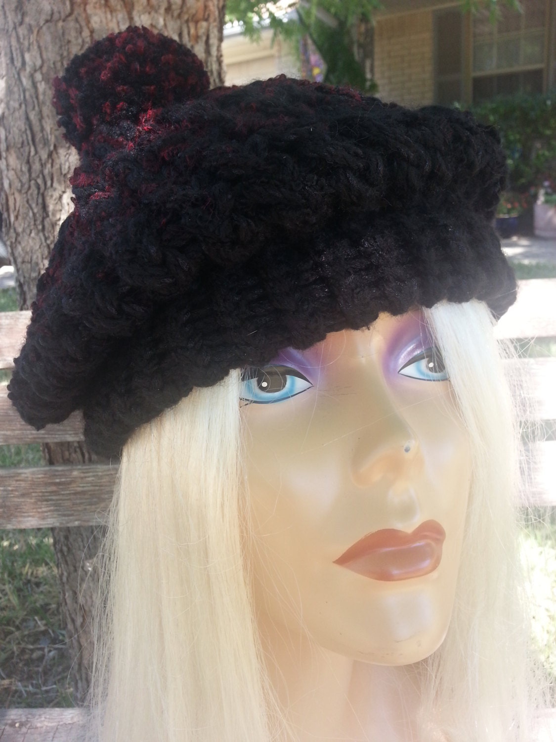 black beret with red pom pom