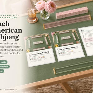 May include: An American Mahjong class kit featuring printed instructor guides and student workbooks with text reading Teach American Mahjong. Includes pink and clear acrylic tile racks, a set of pink tiles, and a green game mat surface.