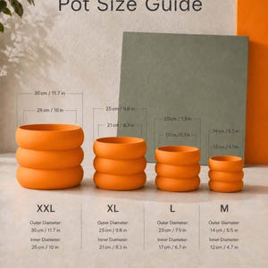 May include: A Pot Size Guide chart displaying four orange, ribbed, cylindrical pots in sizes XXL, XL, L, and M. Each pot is labeled with its outer and inner diameter measurements in both centimeters and inches, ranging from 30 cm/11.7 in to 14 cm/5.5 in.