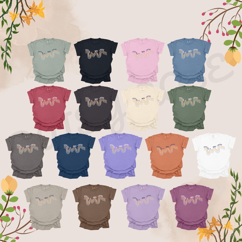 May include: A collection of 18 t-shirts in various colors featuring a colorful wavy line design. The shirts are arranged in a grid pattern.