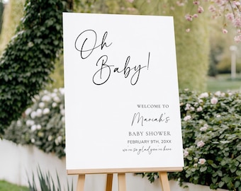 Pode incluir: Uma placa branca em um cavalete de madeira com as palavras "Oh Baby!" em elegante escrita preta. Abaixo, lê-se "Welcome to Mariah's Baby Shower February 9th, 20XX, we're so glad you're here."