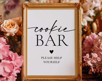 May include: A rectangular sign in an ornate gold frame with white background and black text that reads cookie BAR, a small heart symbol, and the words PLEASE HELP YOURSELF in a clean, centered, and professional font style.