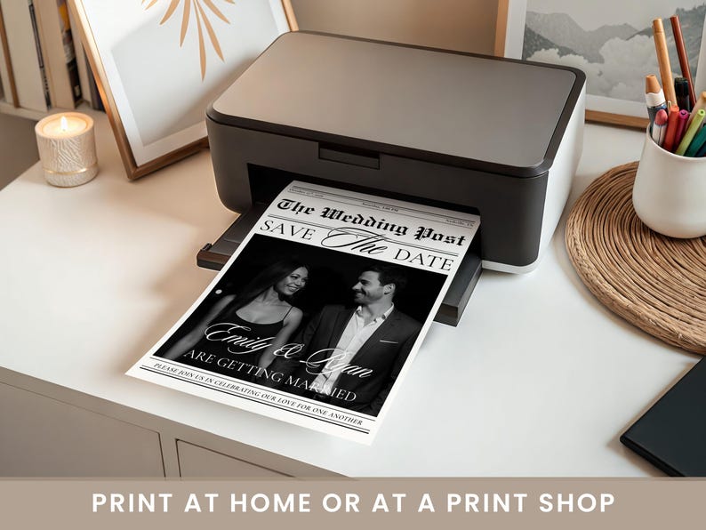 May include: A black and white wedding announcement titled "The Wedding Post" is being printed from a black and grey printer. The announcement reads "Save The Date" and features a photo of the couple, Emily & Quan, with the text "Are Getting Married."