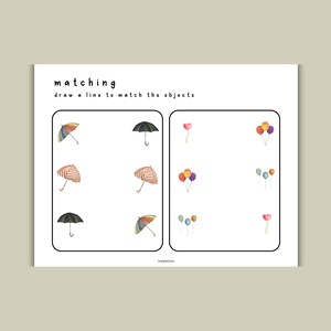 K&ouml;nnte beinhalten: Ein ausdruckbares Arbeitsblatt mit dem Wort "matching" und der Anweisung "draw a line to match the objects". Das Arbeitsblatt hat zwei Spalten, eine mit Bildern von Regenschirmen und die andere mit Bildern von Ballons.