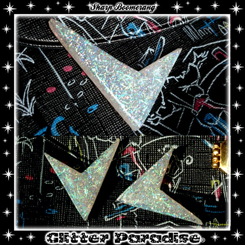 May include: Two silver glitter boomerang shapes on a black background with the text "Sharp Boomerang" and "Glitter Paradise" printed on the fabric.