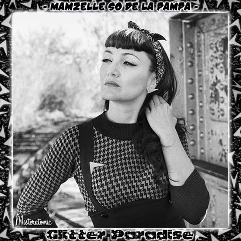 May include: Black and white photo of a woman with dark hair and a headband. She is wearing a black and white patterned sweater with a black skirt. The text "MAMMZELLE SO DE LA PAMPA" is at the top of the image.