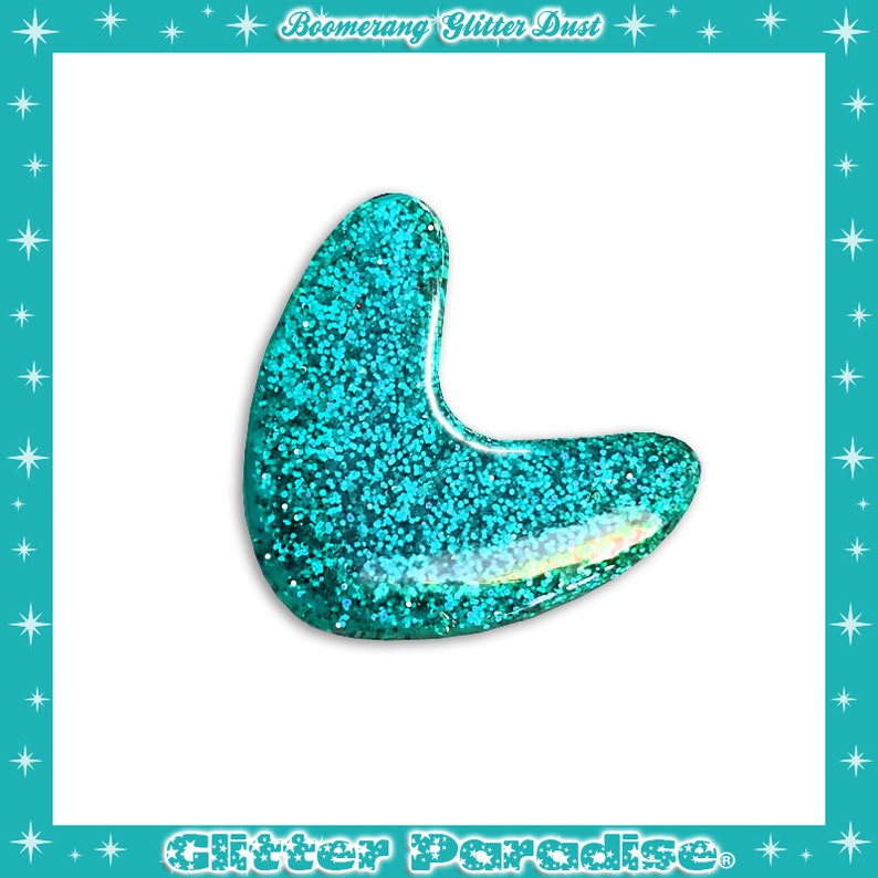May include: A turquoise blue boomerang shaped charm with glitter embedded in the resin.  The charm is a handmade item and is perfect for adding a touch of sparkle to any project.