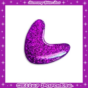 May include: Purple glitter boomerang shape. The glitter is very dense and creates a shiny, sparkly effect.