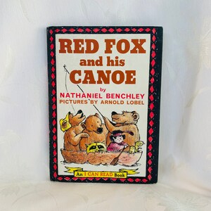 May include: A vintage children's book titled "Red Fox and his Canoe" by Nathaniel Benchley with illustrations by Arnold Lobel. The cover features a red fox, three bears, and a raccoon in a canoe. The book is part of the "I Can Read Book" series.