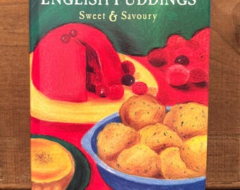 May include: A cookbook titled "English Puddings Sweet & Savoury" with a colorful illustration of various puddings. The cover features a red pudding with berries, golden fried dough balls in a blue bowl, and a yellow dessert on a green plate.