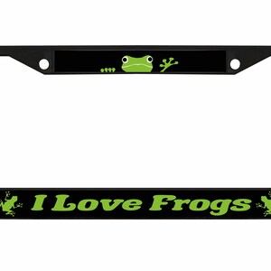 May include: Black car number plate frame with the text "I Love Frogs" in green. The top of the frame features a green frog graphic. The frame is designed to fit a standard UK number plate.