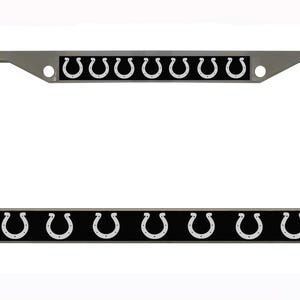 May include: A silver metal license plate frame with a black background and a row of white horseshoe logos.