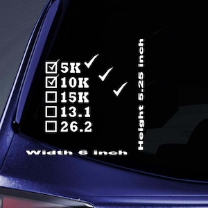May include: White vinyl decal with text and checkmarks. The decal includes checkboxes for 5K, 10K, 15K, 13.1, and 26.2, with checkmarks next to 5K and 10K. The decal is 6 inches wide and 5.25 inches high.