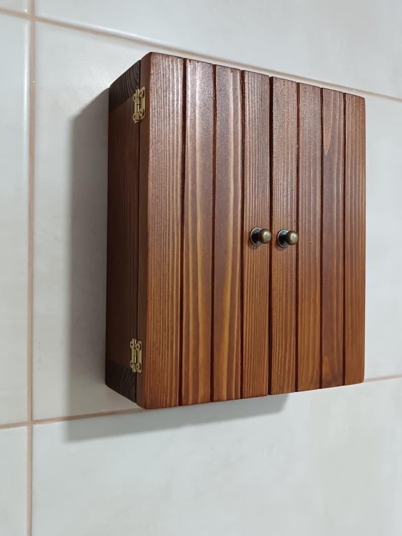 Wall mounted solid wood bathroom cabinet with marine plywood doors and interior shelves for toiletries in modern farmhouse bathroom