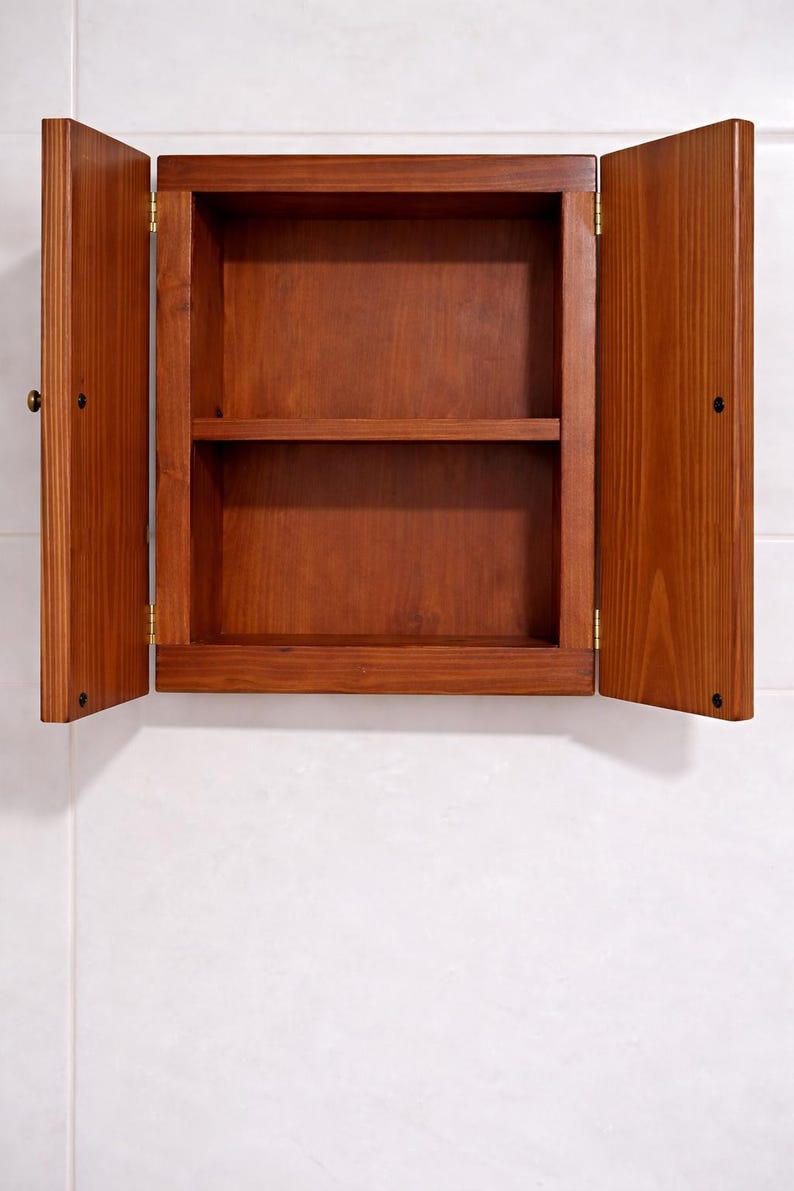 Wall mounted solid wood bathroom cabinet with marine plywood doors and interior shelves for toiletries in modern farmhouse bathroom