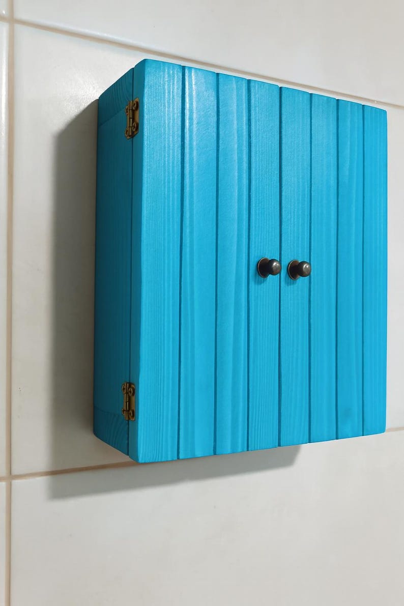 Wall mounted solid wood bathroom cabinet with marine plywood doors and interior shelves for toiletries in modern farmhouse bathroom