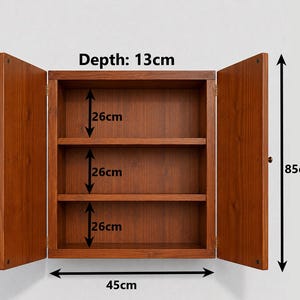 May include: A brown wooden wall cabinet with two open doors and one interior shelf. The cabinet has a total height of 66cm, a width of 45cm, and a depth of 13cm.