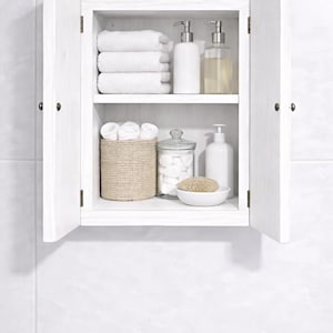 Wall mounted solid wood bathroom cabinet with marine plywood doors and interior shelves for toiletries in modern farmhouse bathroom