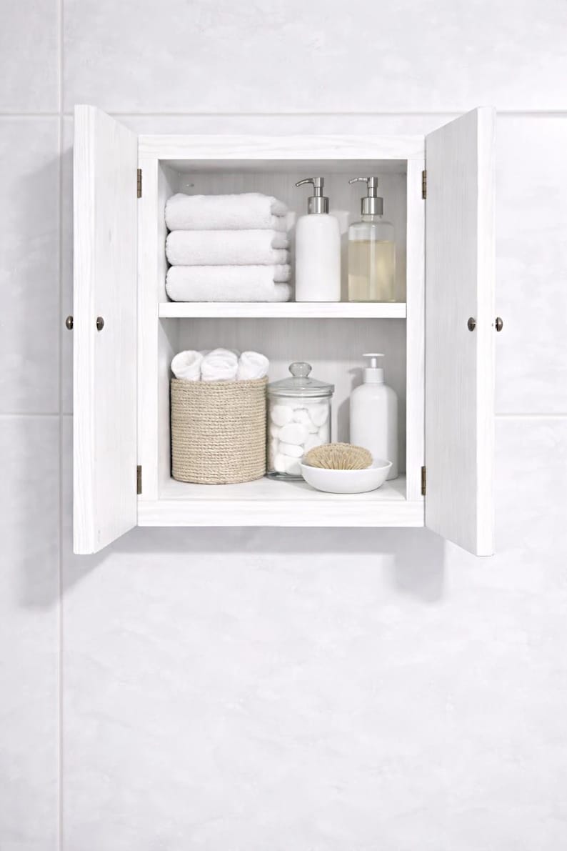 Wall mounted solid wood bathroom cabinet with marine plywood doors and interior shelves for toiletries in modern farmhouse bathroom