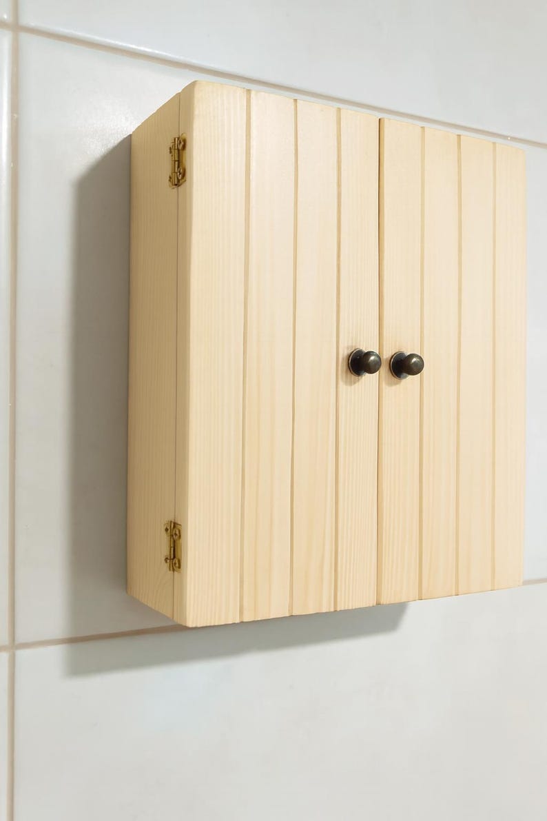 Wall mounted solid wood bathroom cabinet with marine plywood doors and interior shelves for toiletries in modern farmhouse bathroom