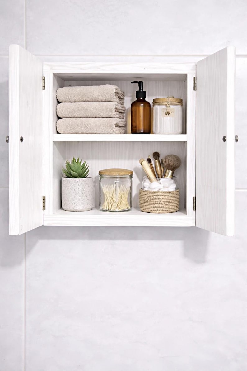 Wall mounted solid wood bathroom cabinet with marine plywood doors and interior shelves for toiletries in modern farmhouse bathroom