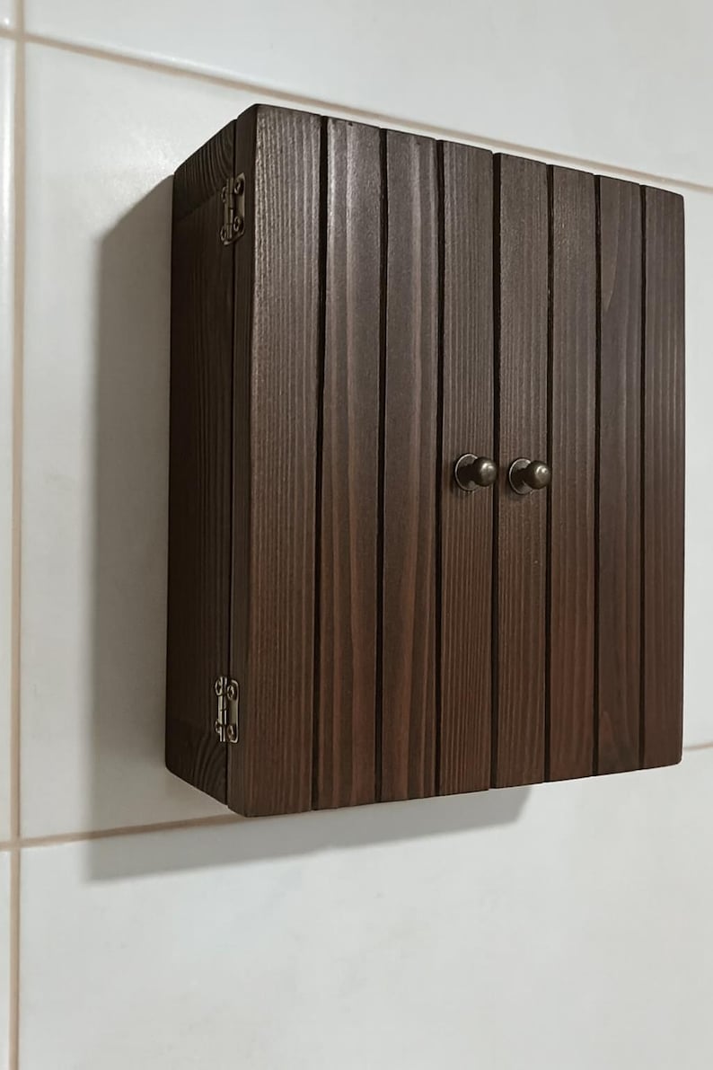 Wall mounted solid wood bathroom cabinet with marine plywood doors and interior shelves for toiletries in modern farmhouse bathroom