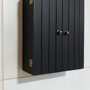 Wall mounted solid wood bathroom cabinet with marine plywood doors and interior shelves for toiletries in modern farmhouse bathroom