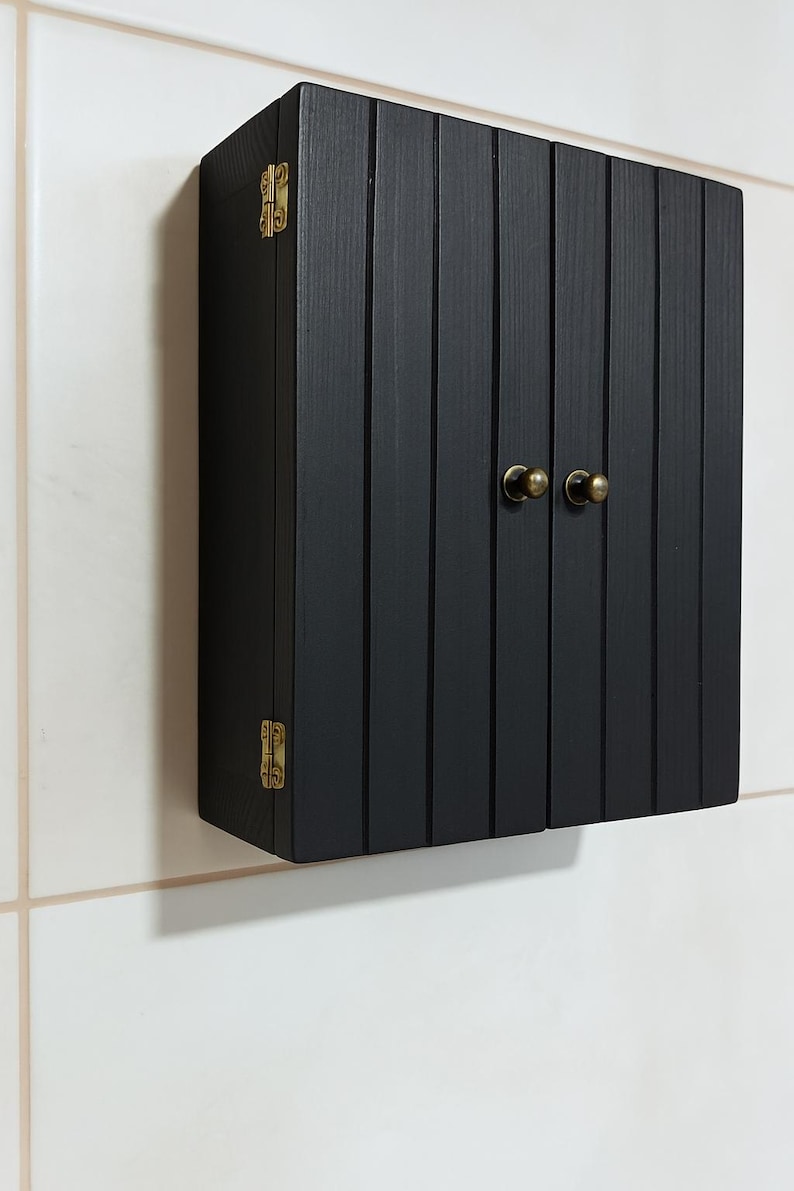 Wall mounted solid wood bathroom cabinet with marine plywood doors and interior shelves for toiletries in modern farmhouse bathroom