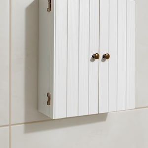 Wall mounted solid wood bathroom cabinet with marine plywood doors and interior shelves for toiletries in modern farmhouse bathroom