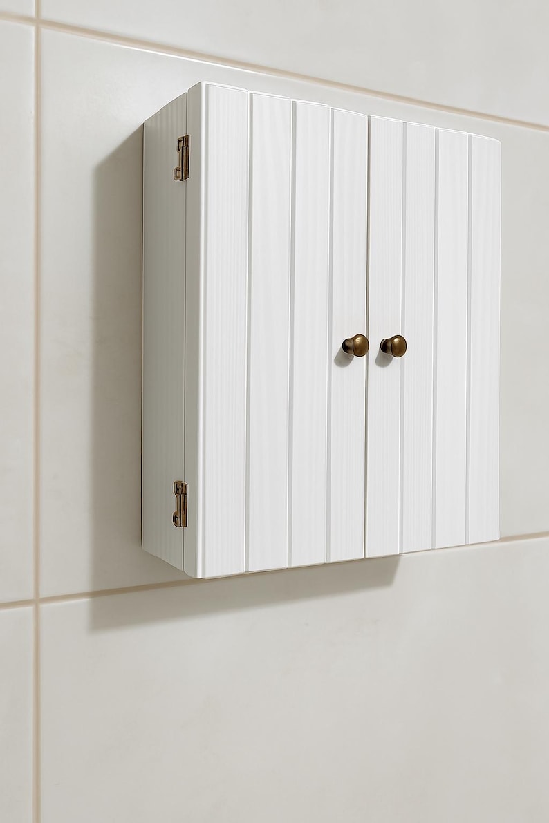 Wall mounted solid wood bathroom cabinet with marine plywood doors and interior shelves for toiletries in modern farmhouse bathroom