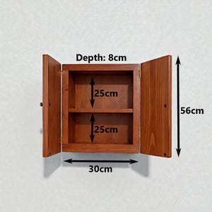 Wall mounted solid wood bathroom cabinet with marine plywood doors and interior shelves for toiletries in modern farmhouse bathroom