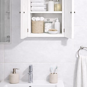 Wall mounted solid wood bathroom cabinet with marine plywood doors and interior shelves for toiletries in modern farmhouse bathroom