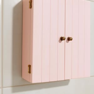 Wall mounted solid wood bathroom cabinet with marine plywood doors and interior shelves for toiletries in modern farmhouse bathroom