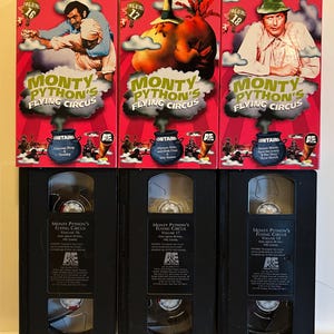 May include: Three VHS tapes of Monty Python's Flying Circus, Volumes 16, 17, and 18. The red boxes feature colorful illustrations and the show's logo. The tapes are black with white text, including the show's title and volume number.
