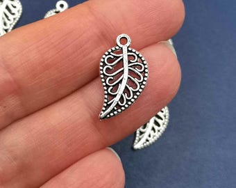 May include: Silver filigree leaf charm pendant with a delicate design. The charm is perfect for jewelry making, scrapbooking, and other craft projects.
