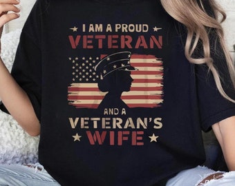 May include: Black t-shirt with a white and red American flag design and the text "I am a proud veteran and a veteran's wife".