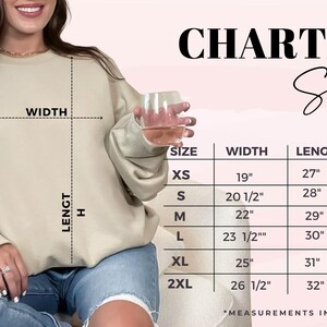May include: Size chart for a sweatshirt with measurements in inches for width, length, and sleeve length. Sizes include XS, S, M, L, XL, and 2XL.
