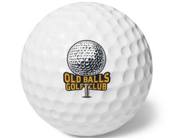 May include: White golf ball with a black and white illustration of a golf ball on a tee with the text "Old Balls Golf Club" in orange letters.