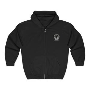 May include: Black zip-up hoodie with a hood and front pockets. A white emblem with text is on the upper left chest. The emblem features a crown, wings, and the text "Psalms 91:16".