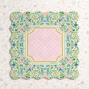 May include: A square scalloped-edge paper napkin featuring a central light pink panel with a white lattice pattern, framed by a gold and light green border. The surrounding border displays a floral pattern with blue birds, pink flowers, and green vines.