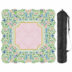 May include: A square scalloped-edge mat featuring a floral pattern with blue birds, pink flowers, and green vines surrounding a central pink diamond-patterned panel with gold and light green borders, accompanied by a black cylindrical carrying bag.